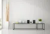 A minimalist interior scene featuring a modern audio system on a glass shelf. Produktbild-Vorschau