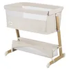 A baby bassinet with a storage basket underneath, shown against a white background. Produktbild-Vorschau
