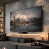 A modern living room with a large TV displaying a city skyline, a plush sofa, and decorative elements. Podgląd zdjęcia produktu