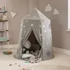 A child's play tent set up in a room with toys and decorations. Podgląd zdjęcia produktu