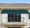A dark green awning is installed above a balcony on a building. Produktbild-Vorschau