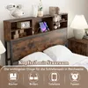 A bed headboard with integrated storage and charging features, shown in a bedroom setting. Náhled obrázku produktu
