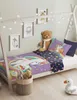 A child's bed with unicorn-themed bedding, a teddy bear, and decorative lights. Náhľad obrázku produktu