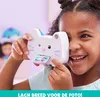 A young girl is holding a toy camera shaped like a cat and smiling. Produktbild-Vorschau