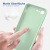 A hand is touching a light green silicone phone case, with fluffy white material in the background. Produktbild-Vorschau