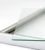 A close-up shot of a silver picture frame with a piece of glass resting on it. Produktbild-Vorschau