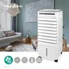 A mobile air cooler is shown in a living room setting next to a sofa and a decorative painting on the wall. Produktbild-Vorschau