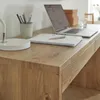 A close-up view of a wooden desk surface with office supplies. Produktbild-Vorschau