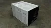 A cardboard box with product information printed on it, sitting on a concrete floor. Náhľad obrázku produktu