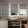 A bathroom vanity with a sink and three windows covered by zebra blinds. Voir les images du produit