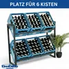 A two-tiered metal rack holding blue crates filled with brown bottles, likely beer bottles, with a potted plant on the right. Náhled obrázku produktu