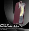 A close-up marketing shot of a red leather phone case, partially covering a smartphone. Anteprima dell’immagine prodotto