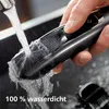 A hand is holding a Philips S5000 beard trimmer under running water from a faucet, demonstrating its waterproof feature. Text indicating "100 % wasserdicht" (100% waterproof) is visible at the bottom. Produktbild-Vorschau