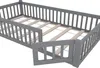 A close-up view of a grey wooden bed frame with a slatted base, showing the railing and an open doorway. Anteprima dell’immagine prodotto