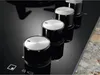 Close-up of four control knobs on a black gas hob. Voir les images du produit
