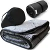A folded camping blanket with a storage bag and a rolled-up blanket. Produktbild-Vorschau