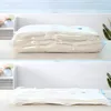 Two images showing vacuum seal bags for storage. The top image shows a bag filled with folded white textiles, appearing plump. The bottom image shows the same bag after vacuum sealing, appearing flat and compressed. Náhled obrázku produktu