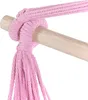 A close-up of a pink rope knotting around a wooden dowel, likely part of a hammock chair. Podgląd zdjęcia produktu
