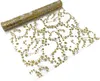A roll of transparent fabric with gold stars printed on it, unrolled to show the pattern. Produktbild-Vorschau