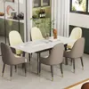 A dining room setting with a marble-look extendable dining table and chairs. Produktbild-Vorschau