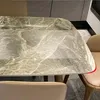 Close-up of a marble-patterned dining table with chairs. Produktbild-Vorschau