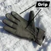 A black glove is shown on a white, snowy surface. The glove has textured grip areas on the palm and fingers. Produktbild-Vorschau