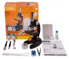 A National Geographic microscope kit is displayed on a white background, including the microscope, its packaging, and various accessories. Náhľad obrázku produktu