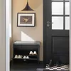 An entryway scene featuring a shoe cabinet with a bench seat, a door, and a framed picture on the wall. Anteprima dell’immagine prodotto
