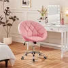 A pink tufted swivel chair in a room with a vanity and a bed. Produktbild-Vorschau