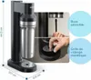 A soda maker with a close-up of a hand interacting with a part of the device, and callouts highlighting features. Produktbild-Vorschau