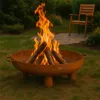 A fire pit with burning logs in a backyard setting with a chair in the background. Anteprima dell’immagine prodotto