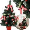 A collage of images showing a decorated artificial Christmas tree in a red pot, with close-ups of its decorations and a lifestyle shot of a similar tree in a room setting. Náhled obrázku produktu