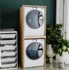 A laundry room with a stacked washer and dryer unit, laundry baskets, and plants. Produktbild-Vorschau