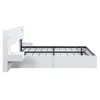 A side view of a modern white bed frame with a metal mattress support. Produktbild-Vorschau