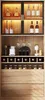 A well-lit display cabinet showcasing various bottles, jars, and kitchenware, with a focus on a wine rack and storage drawers. Náhled obrázku produktu