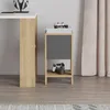 A bedside table with gaming controllers and consoles on it, next to a desk with headphones. Podgląd zdjęcia produktu