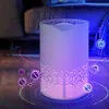 An air purifier with purple and pink lights is shown in a living room setting, with stylized virus icons around it. Produktbild-Vorschau