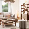 A living room scene with a sofa, coffee table, and bookshelf. Podgląd zdjęcia produktu