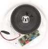 A close-up view of the internal components of a white electronic device, likely a doorbell or alarm, showing a speaker, circuit board, and wiring. Podgląd zdjęcia produktu