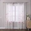 A window with sheer curtains featuring a floral pattern. Produktbild-Vorschau