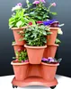 A multi-tiered planter with various flowering plants. Anteprima dell’immagine prodotto