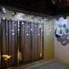 Outdoor patio with string lights and a mural. Náhled obrázku produktu