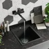 A modern kitchen sink area with a black faucet and sink, set against a hexagonal tile backsplash. Produktbild-Vorschau