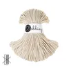 A skein of beige macrame cord with a label. Podgląd zdjęcia produktu