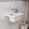 A white sink with a flexible white faucet is mounted on a tiled wall. A soap dispenser is to the left of the faucet, and a mop bucket is visible to the right. Produktbild-Vorschau