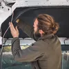A man is working on the interior of a vehicle, possibly a van, installing soundproofing material on the ceiling. Produktbild-Vorschau