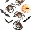 Halloween-themed decorations including spider cookies and a small pumpkin. Náhled obrázku produktu