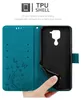 A hand is holding open a teal flip phone case, revealing the black TPU shell inside. Náhled obrázku produktu