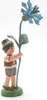 A small figurine of a boy holding a blue cornflower. Produktbild-Vorschau