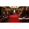 A group of anime-style characters are in a dimly lit, luxurious room with a red carpet and bar. Podgląd zdjęcia produktu